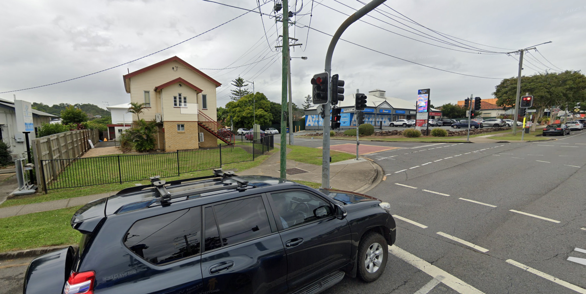 Street view of the little cream cottage at 108 Beaudesert Road, Moorooka, across from the pharmacy