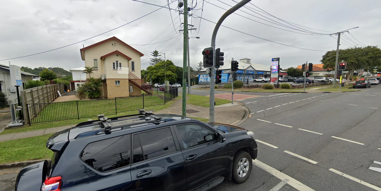 Street view of the little cream cottage at 108 Beaudesert Road, Moorooka, across from the pharmacy